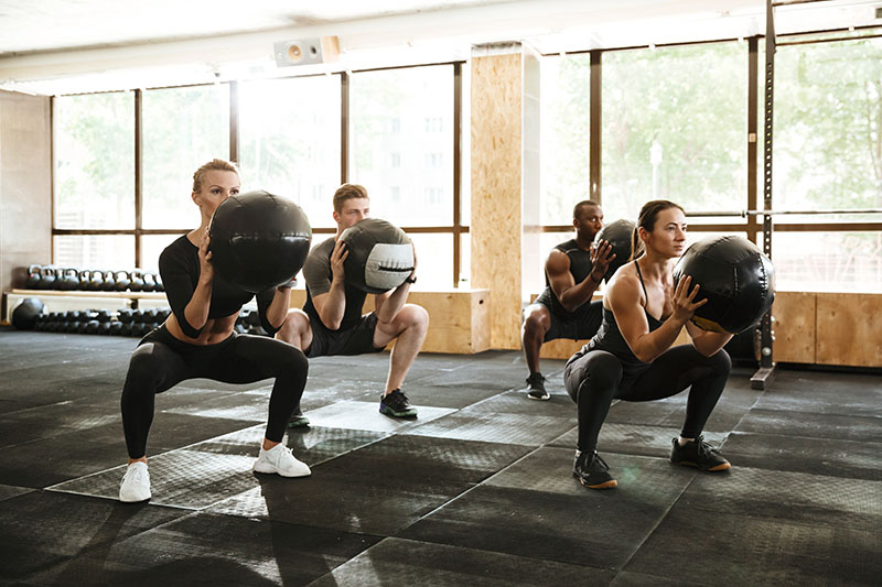 people doing sport exercise with a ball.
